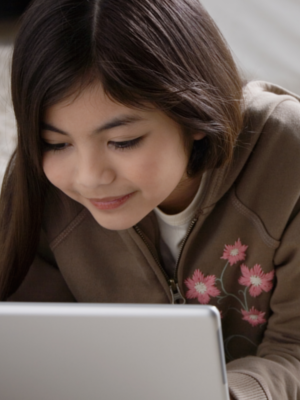 Tween girl using a laptop