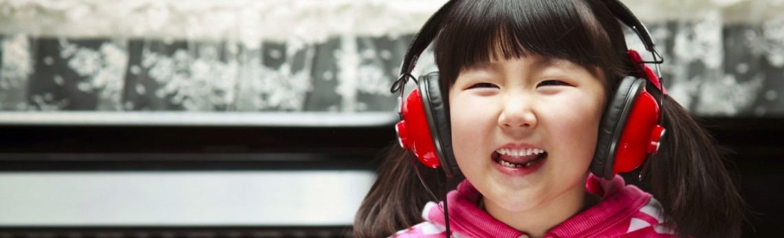 Girl in headphones, smiling