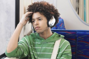 teen-boy-wearing-headphones-on-bus