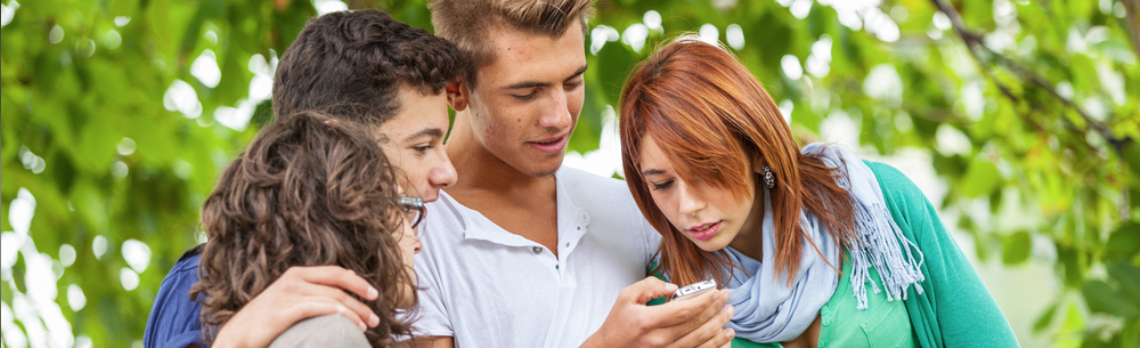 young adults looking at mobile media