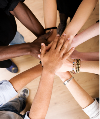 various teens with hands in a circle