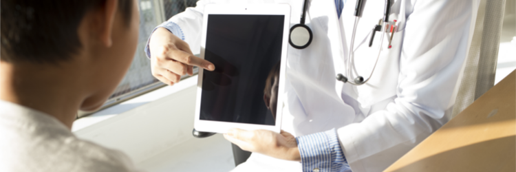 A healthcare professional showing a child an iPad