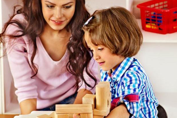 Woman and young girl playing with blocks