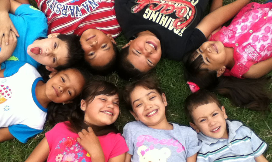 children lying on grass