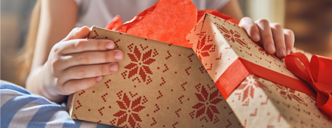 Close up of a girl's hands opening a present